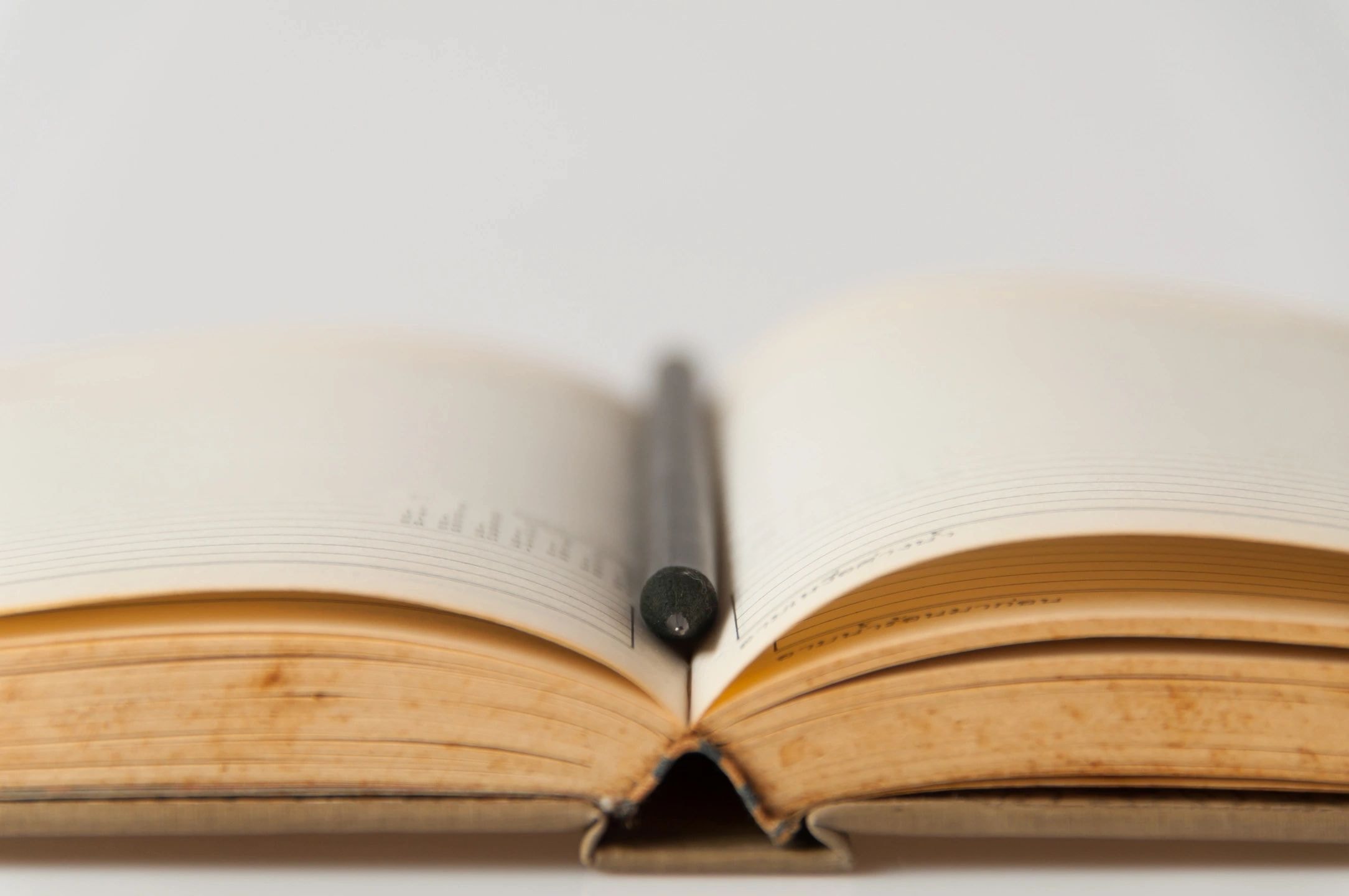 Open book with pen on desk